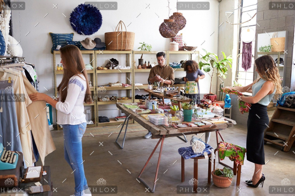 demo-attachment-607-customers-and-staff-in-a-busy-clothes-shop-PKWD8LW